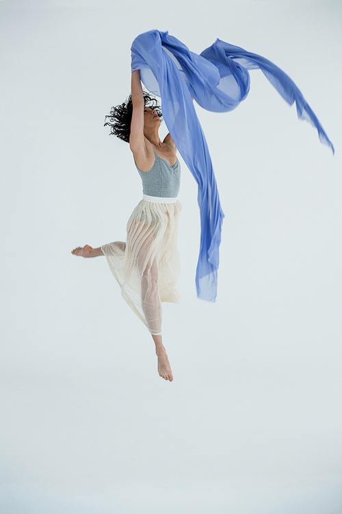 Dancer practicing contemporary dance in dance studio