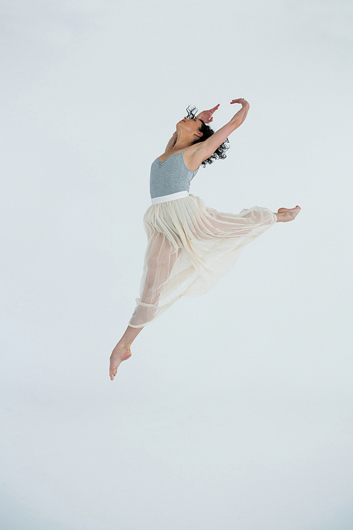 Dancer practicing contemporary dance in dance studio