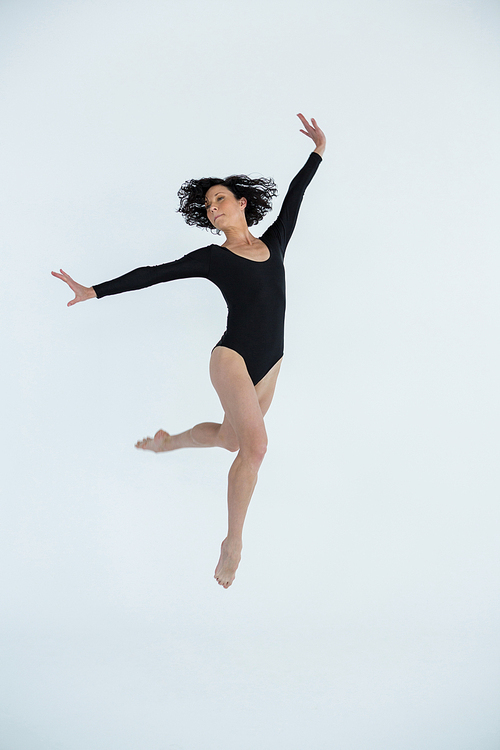 Dancer practicing contemporary dance in dance studio