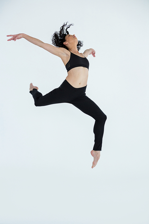 Dancer practicing contemporary dance in dance studio