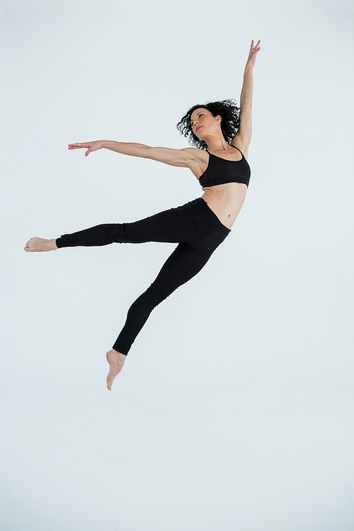 Dancer practicing contemporary dance in dance studio