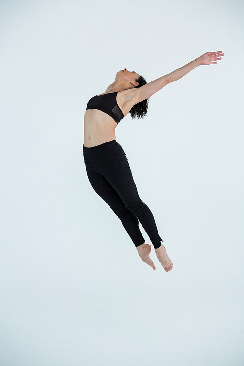 Dancer practicing contemporary dance in dance studio