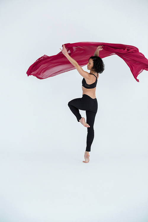 Dancer practicing contemporary dance in dance studio