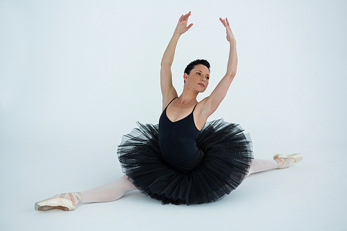 Ballerina performing a split in the ballet studio