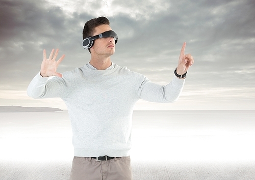 Digital composition of man using virtual reality glasses against sky in background