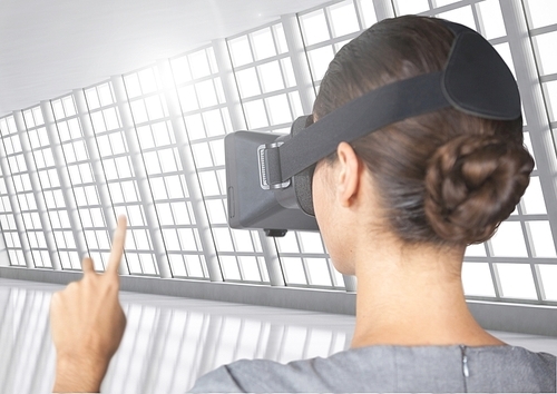 Woman using virtual reality headset in room