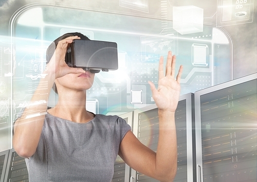 Digital composition of woman using virtual reality headset against server systems in background