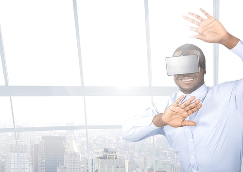 Businessman using virtual reality headset at office against cityscape in background