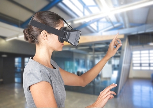 Woman using virtual reality headset at office