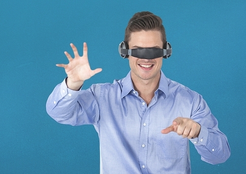 Man using virtual reality headset against blue background