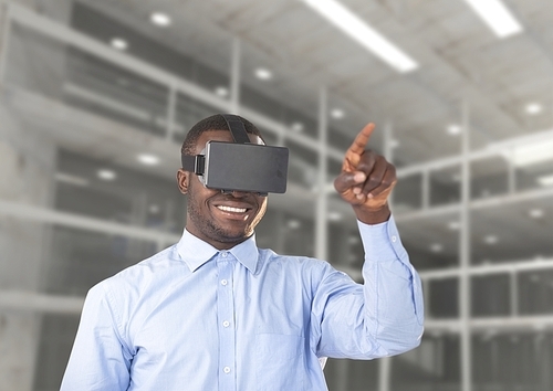 Digital composition of man using virtual reality headset against office in background