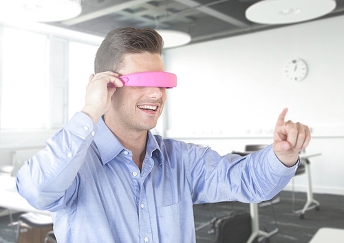 Handsome man using virtual reality glasses at office