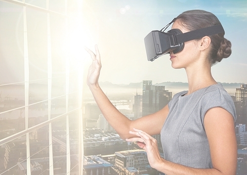 Digital composition of businesswoman using virtual reality headset against office buildings in background