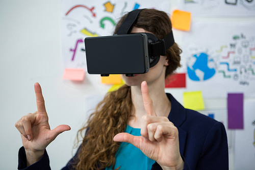 Close-up of woman using virtual reality headset in creative office