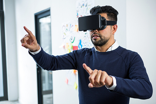 Graphic designer using the virtual reality headset in creative office