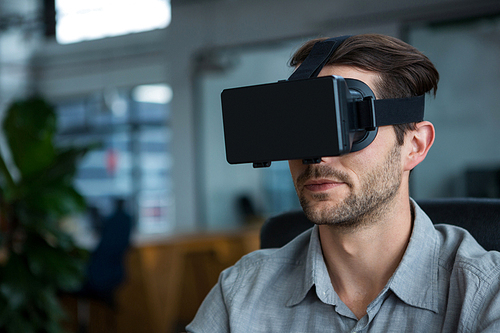 Close-up of man using virtual reality headset in creative office