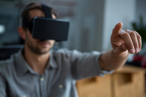 Close-up of man using virtual reality headset in creative office