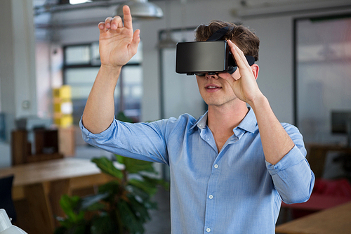 Man using virtual reality headset in creative office