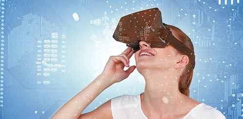 Close up of woman using virtual reality headset against micro parts of mother board