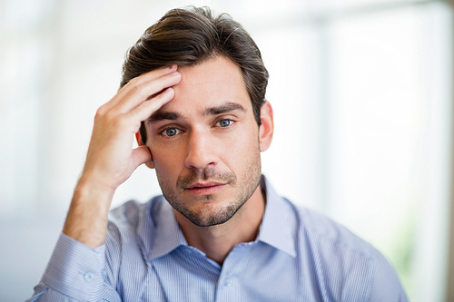 Close-up of worried businessman with hand on head