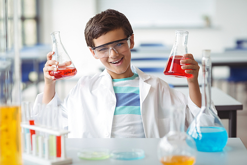 Portrait of schoolboy doing a chemical experiment in laboratory at school