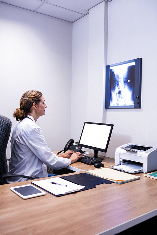 유토이미지 | Attentive doctor working on computer in clinic at hospital