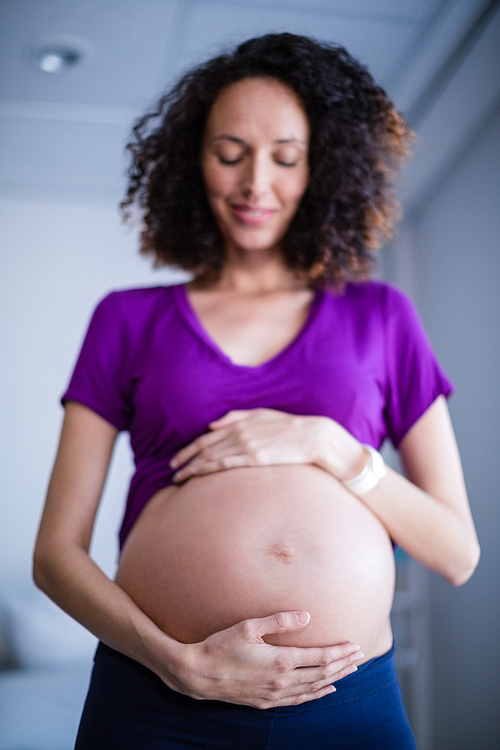 Pregnant Woman Standing In Ward Of Hospital