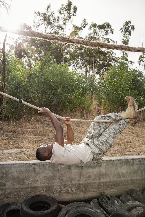 young military soldier practicing rope climbing during obstacle course at 군사훈련