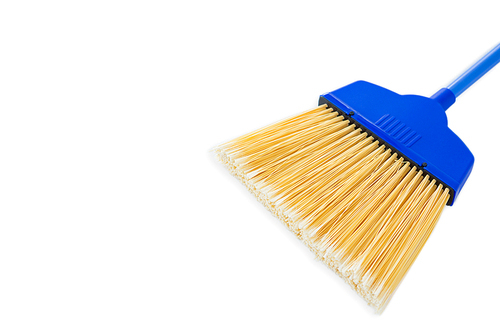Close-up of blue broom against white background