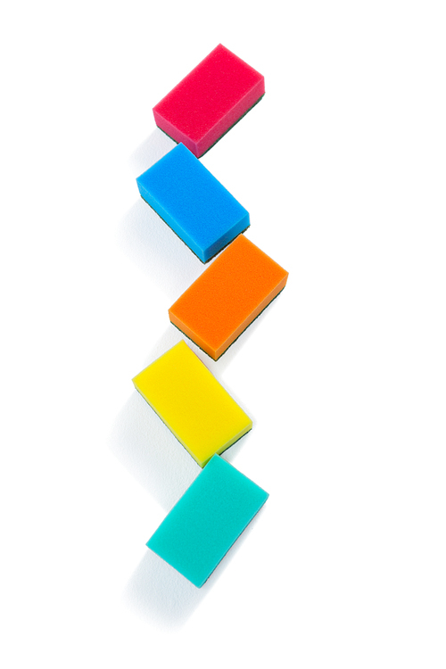 High angle view of colorful sponges against white background