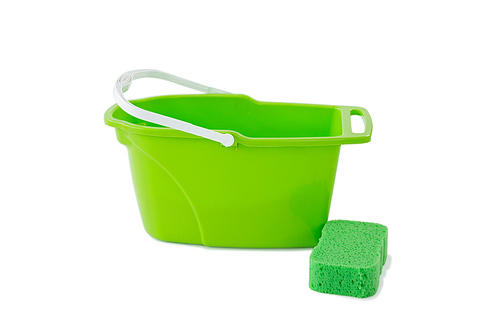 Close-up of green bucket with cleaning sponge against white background