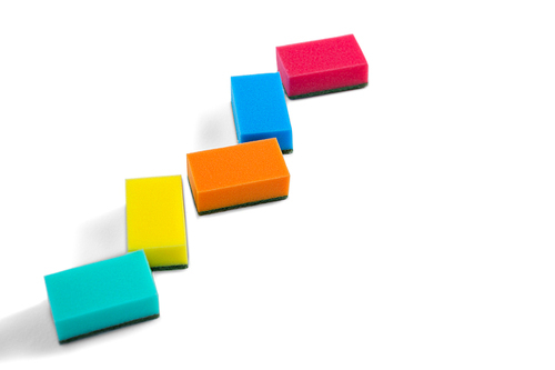 High angle view of colorful cleaning sponges against white background
