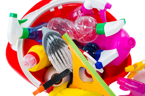 Close-up of cleaning equipment in bucket against white background