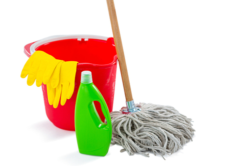 Close up of cleaning products and mop with bucket against white background