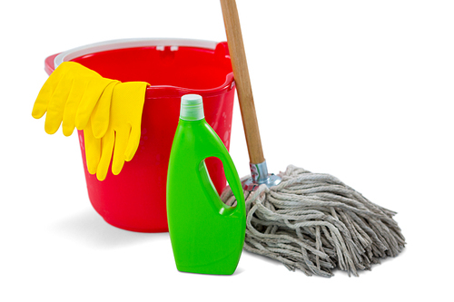 Close up of chemical bottle and mop with bucket against white background