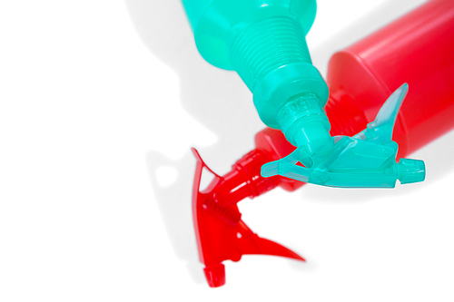 High angle view of spray bottles against white background