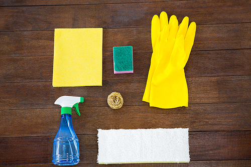 Overhead view of cleaning products on wooden table