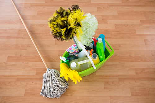 High angle view of mop and cleaning equipment in bucket on hardwood floor
