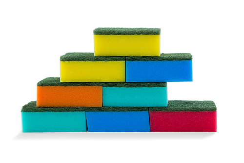 Close up of stacked colorful sponges against white background
