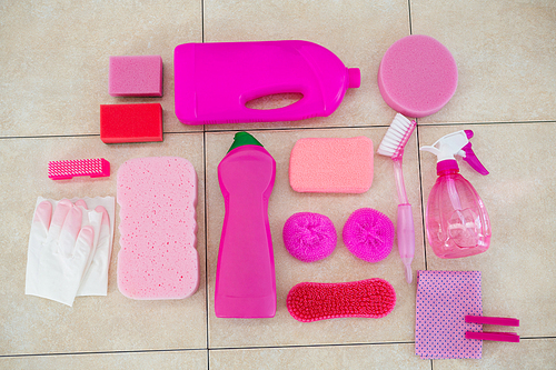 Overhead view of pink color cleaning equipment on tiled floor