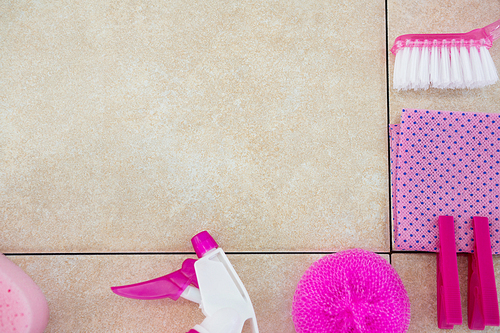Cropped image of pink cleaning equipment on tiled floor