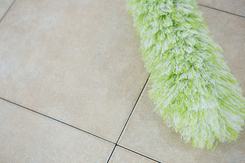 Close up of duster on tiled floor