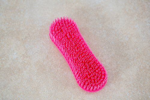 Close up of pink brush on tiled floor