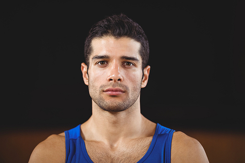 Portrait of male basketball player standing in basketball court
