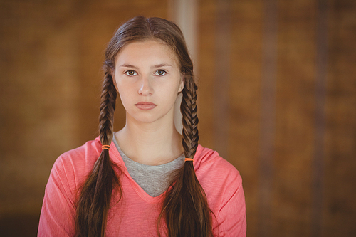 Portrait of high school girl standing in basketball court