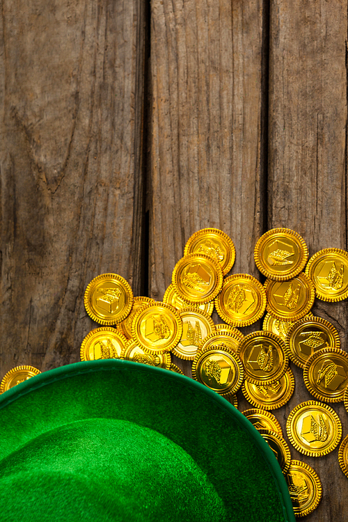 St Patricks Day leprechaun hat with gold chocolate coins??on wooden background