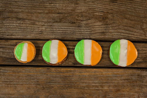 St. Patricks Day four cookies with irish flag toppings on wooden background