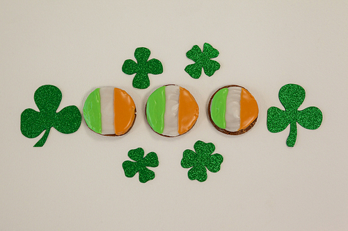 St. Patricks Day cookies decorated with irish flag surrounded with shamrocks on white background