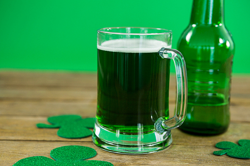 St Patricks Day green beer with shamrock on wooden surface