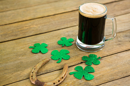 St Patricks Day green beer with shamrock and horseshoe on wooden surface